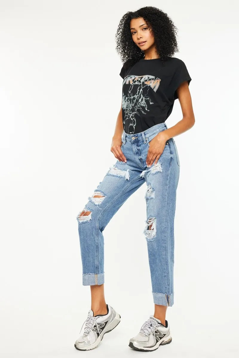Side view: medium-wash boyfriend jeans with wide rips and frayed ankle hem