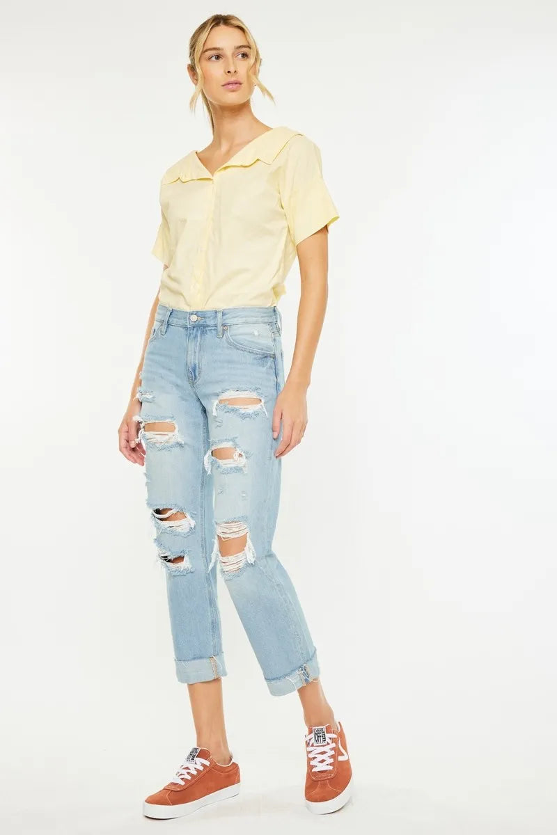 Light wash distressed boyfriend jeans, four-pocket style and relaxed cropped fit