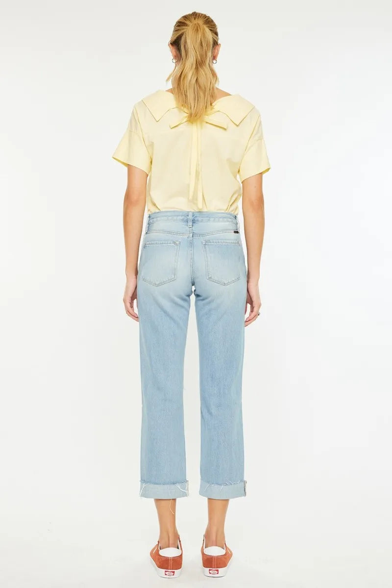 Back view: light wash boyfriend jeans with straight legs and rear yoke seams