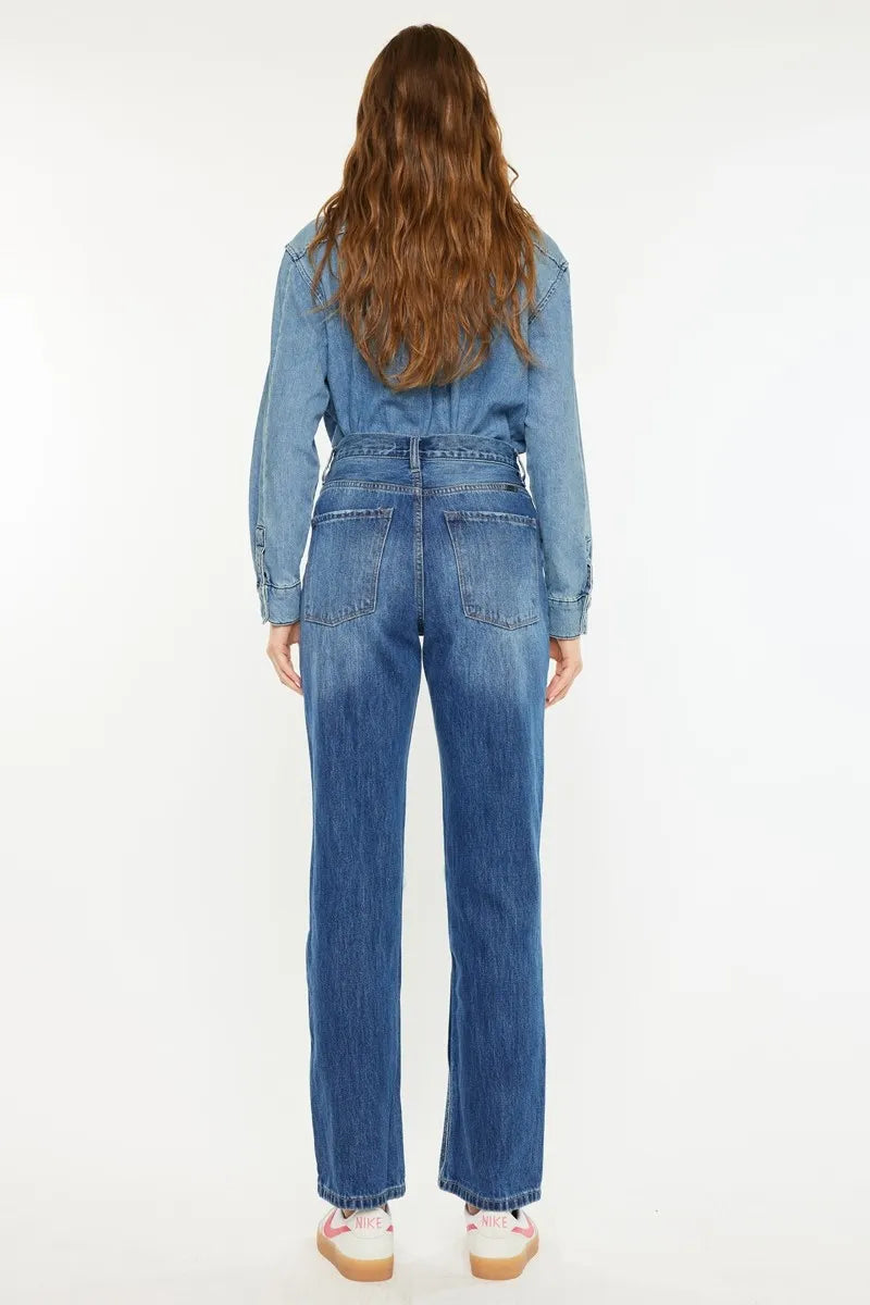 Rear view of medium wash boyfriend jeans with high-rise fit and distressed back pockets