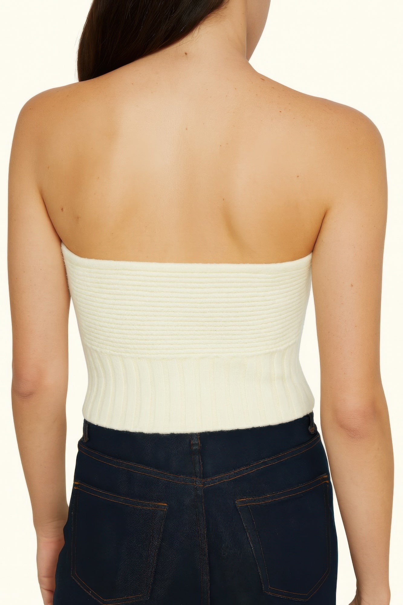 Back view of cream knit tube top with ribbed texture and straight strapless fit