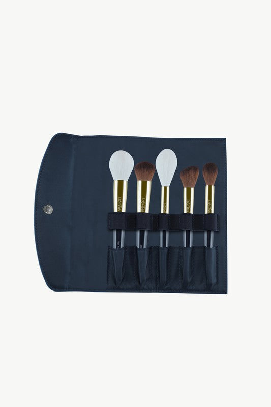Blue brush roll pouch holding five brushes in fabric slots, gold caps, dark bristles