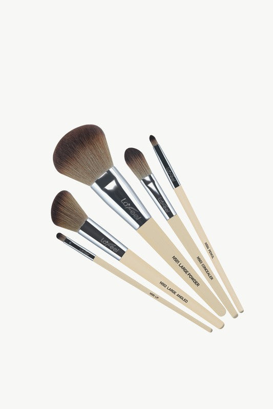 Five-piece brush set laid out diagonally; beige handles, dark bristles, silver ferrules