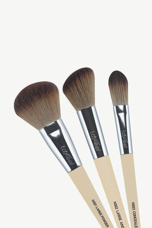 Close view of 3 brushes: large, medium and small; beige handles, dark bristles