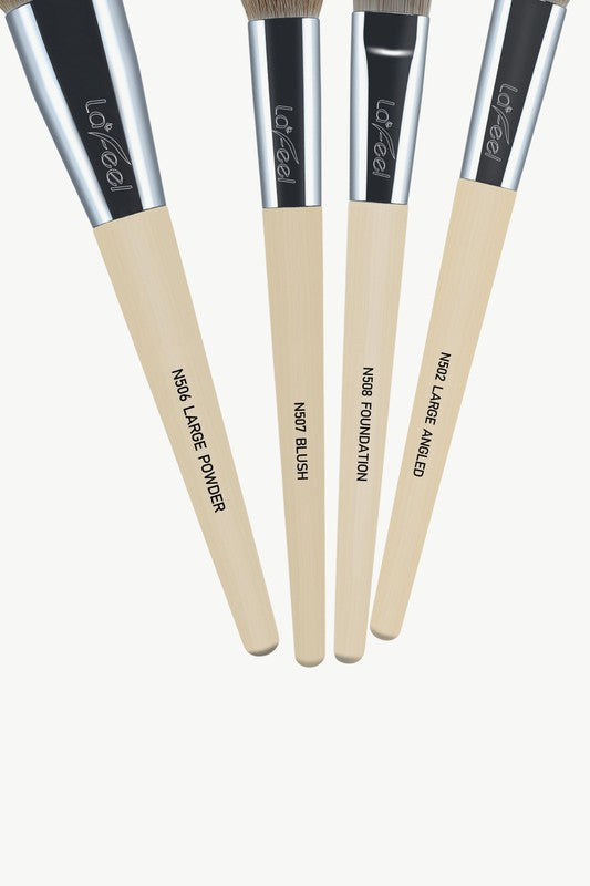 Close-up of beige-handled brushes with brown bristles and black ferrules