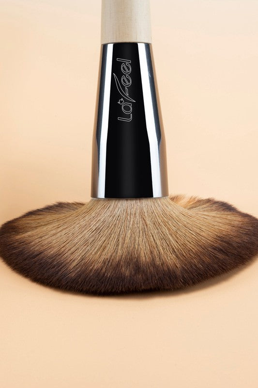 Single brush head with brown bristles on beige handle and black ferrule