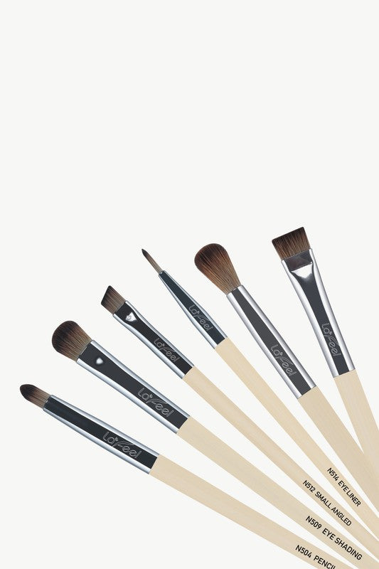 Angle view of Lafeel eye brushes with brown bristles and mixed handle finishes