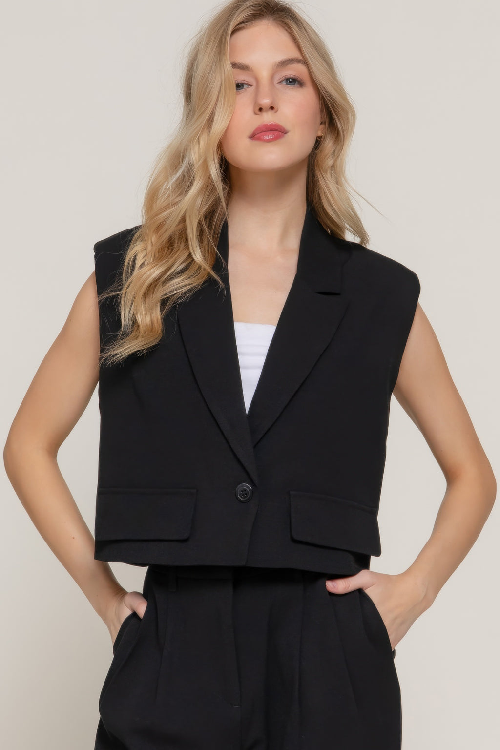 Black lapel collar vest with shoulder pads and button front