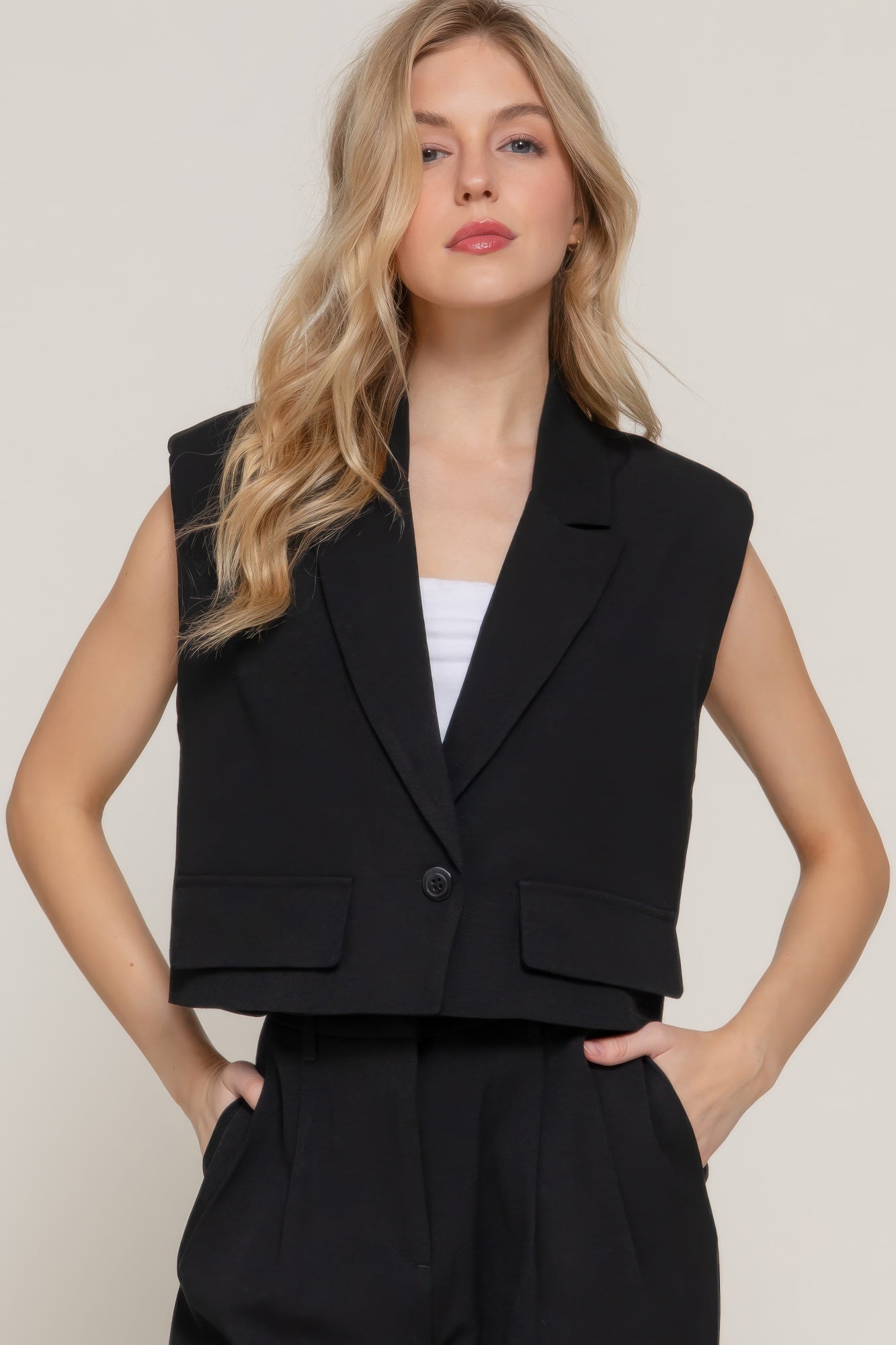 Black lapel collar vest with shoulder pads and button front