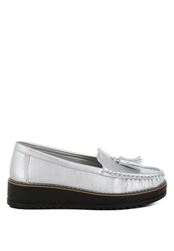 Silver metallic slip-on loafer with tassel detail and stitched edge, black sole