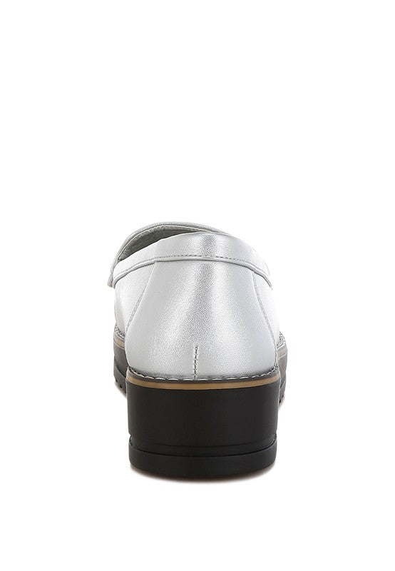 Silver metallic loafers heel view, smooth upper and black platform sole