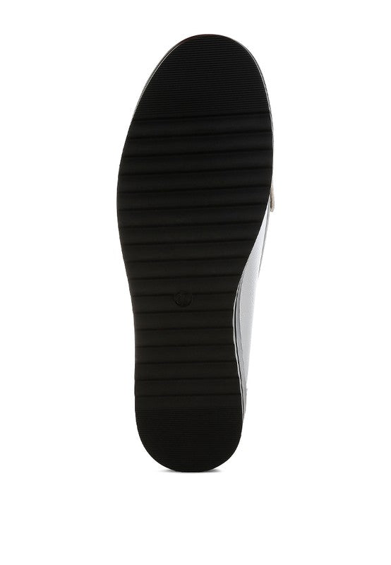 Silver metallic loafer outsole with textured tread and black rubber sole