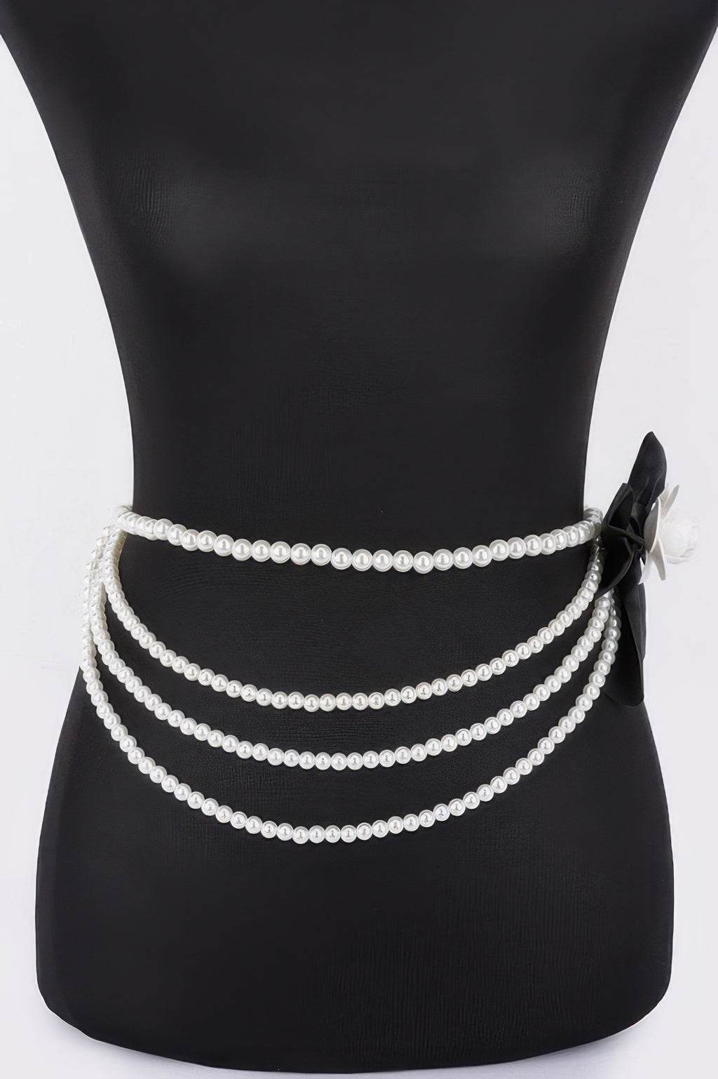 Black layered faux pearl ribbon belt, three pearl strands with bow and flower detail