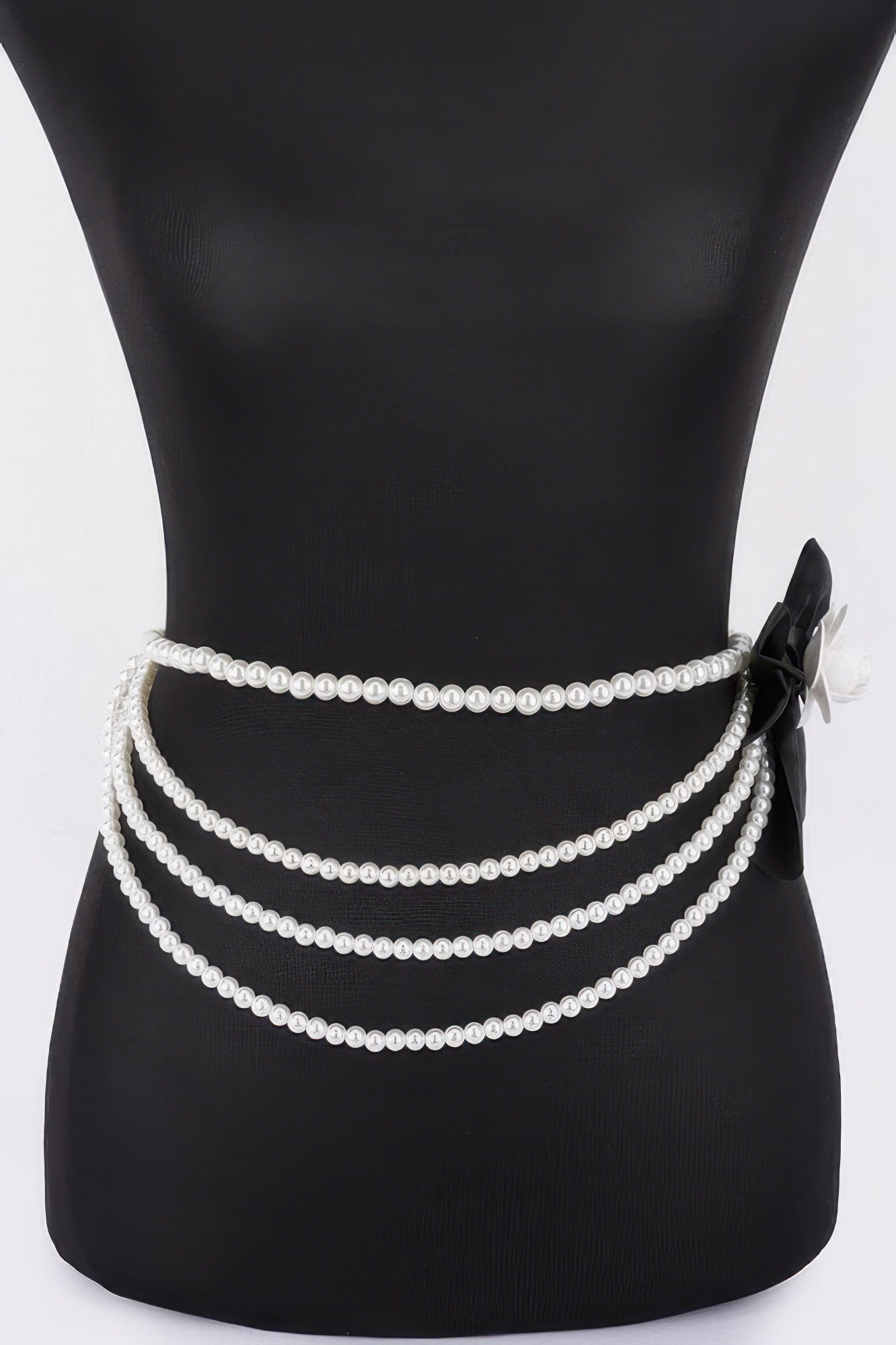 Black layered faux pearl ribbon belt, three pearl strands with bow and flower detail
