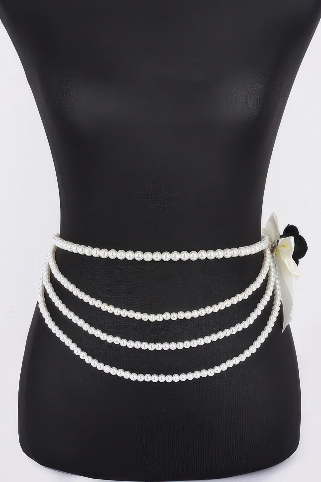 Black layered faux pearl ribbon belt with bow flower at right and three pearl rows
