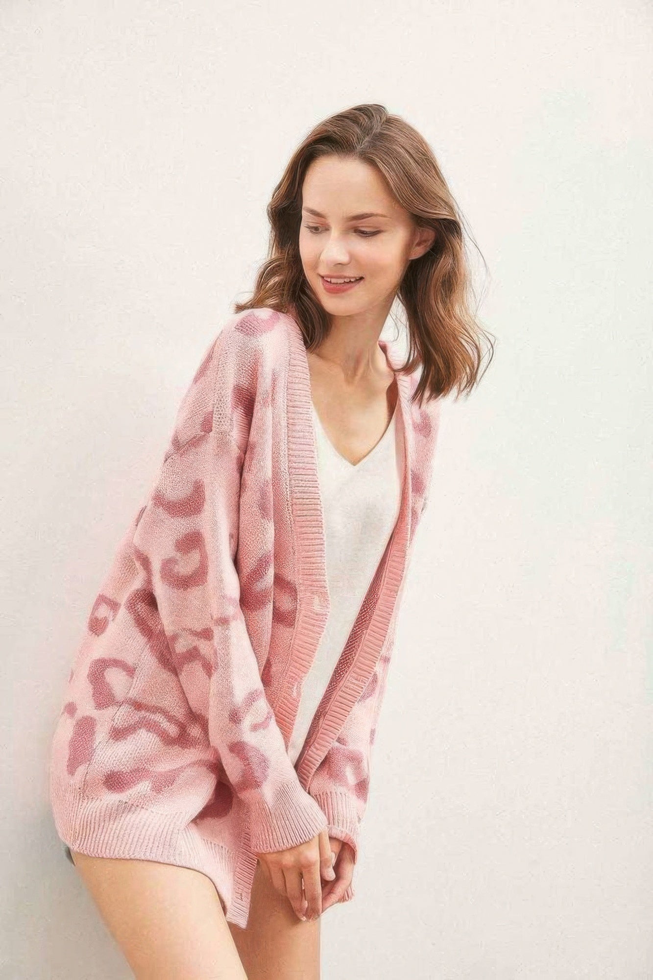 Pink leopard cardigan with open button front and ribbed knit cuffs