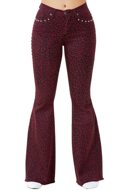 Burgundy leopard-print flare jeans with button front and silver stud details