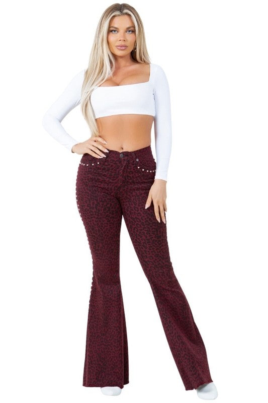 Burgundy leopard-print bell-bottom jeans with silver-stud waistband detailing