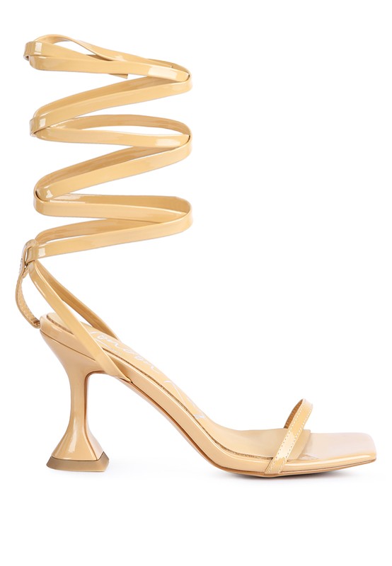 Nude strappy tie-up spool heel sandals, side view with spiral ankle tie and thin heel