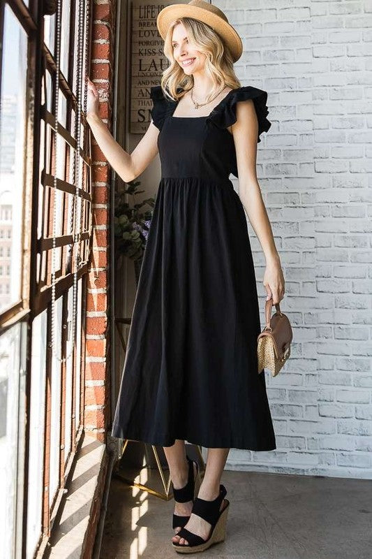 Black mid dress with open back and ruffled shoulder details