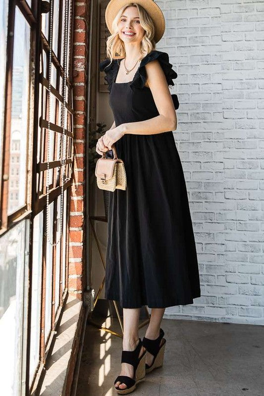 Black midi dress with open back and tied bow at the back