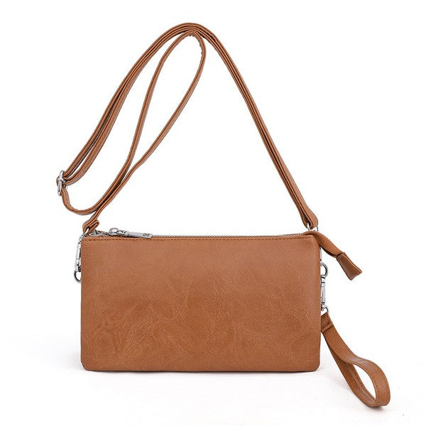 Cognac compact crossbody purse with adjustable shoulder strap and zipper top