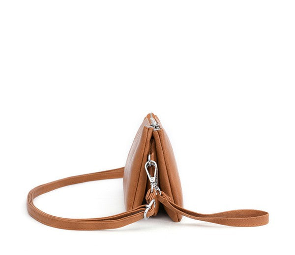 Cognac compact crossbody bag side view with adjustable strap and metal zipper pulls