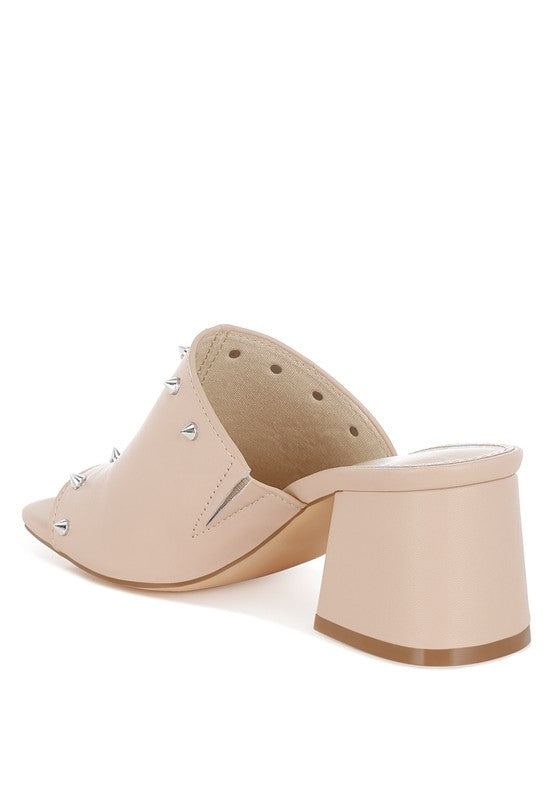 Beige slide mule with block heel and metal stud trim at sides