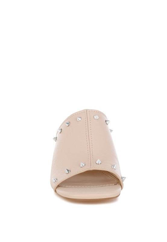 Beige mule with studded V strap and block heel; open toe