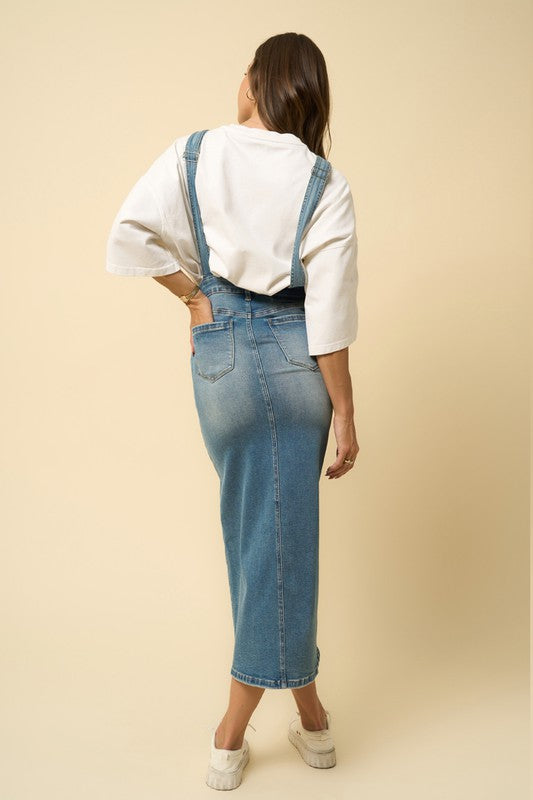 Denim blue long skirt overalls, back view, with buttoned straps and fitted seams