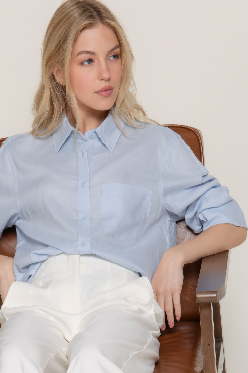 Light blue button-up linen-blend shirt, sleeves cuffed, chest pocket detail