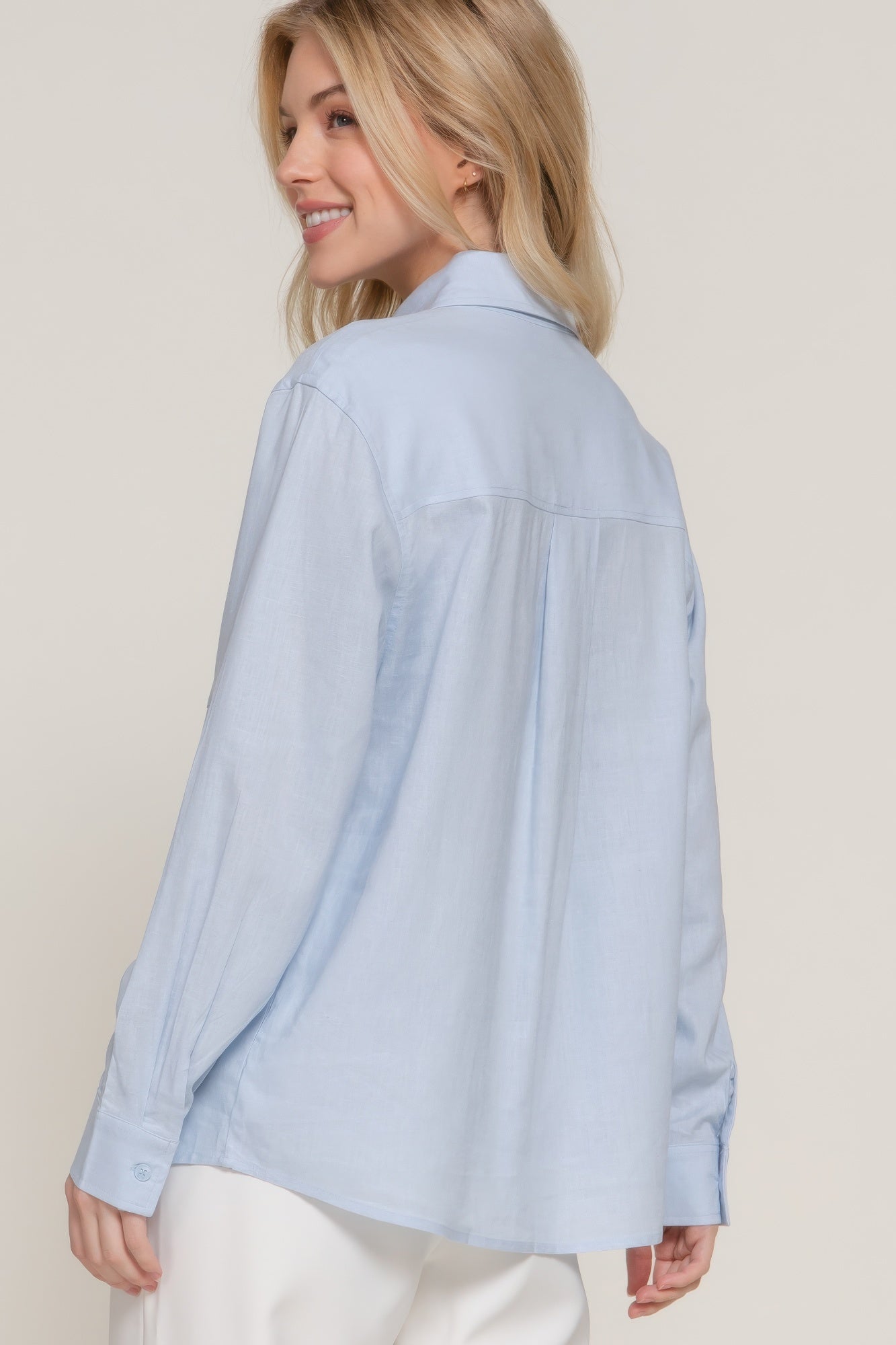 Light blue long sleeve linen-blend shirt from back view, curved hem and seam details