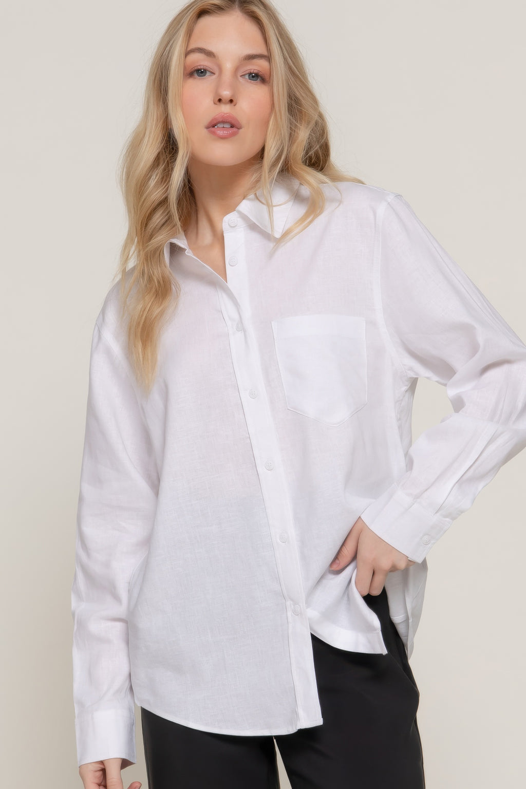 White long-sleeve linen-blend shirt close-up: pointed collar and front buttons