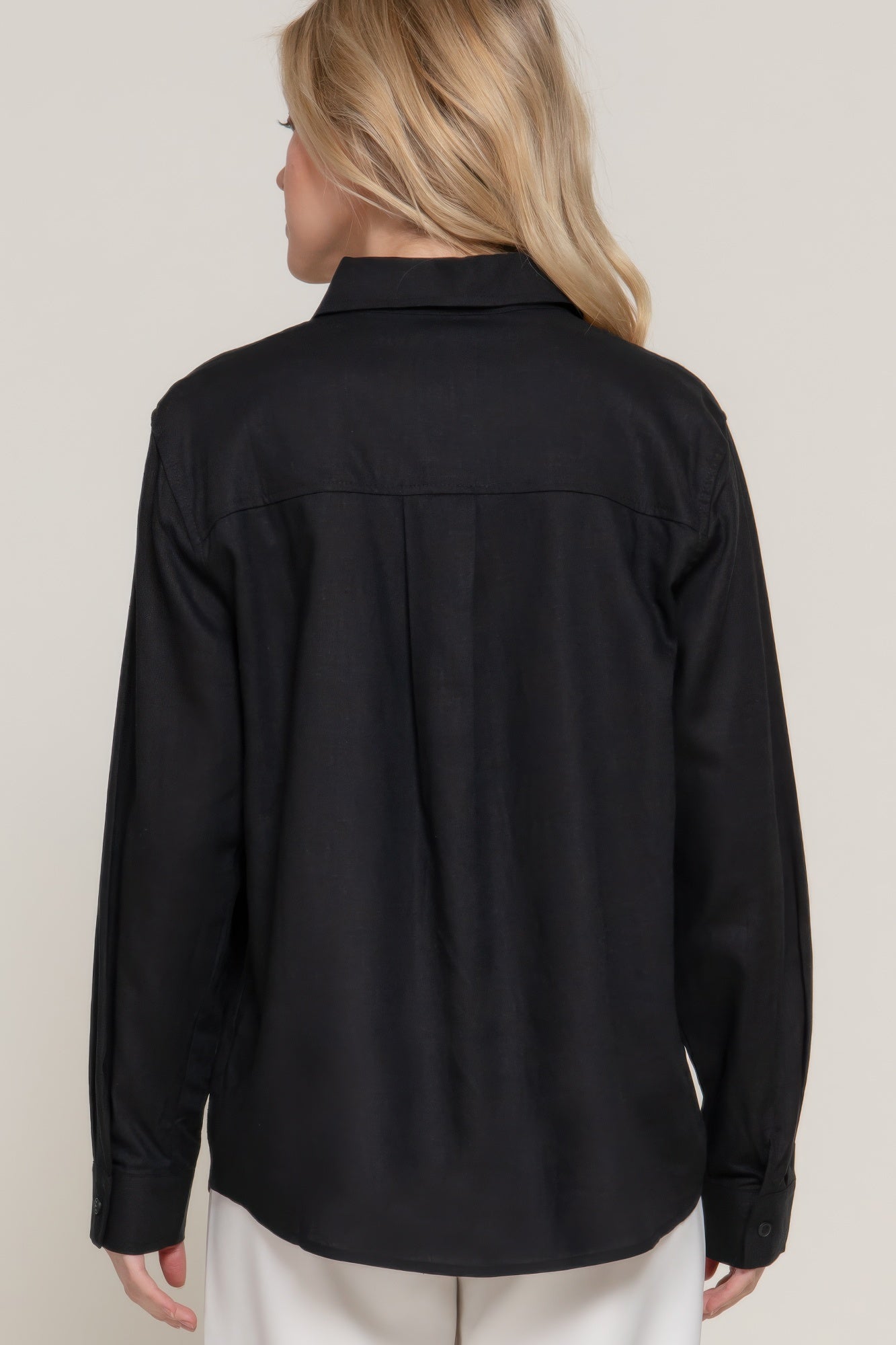Black long sleeve linen blend shirt back view; yoke seams and button cuff