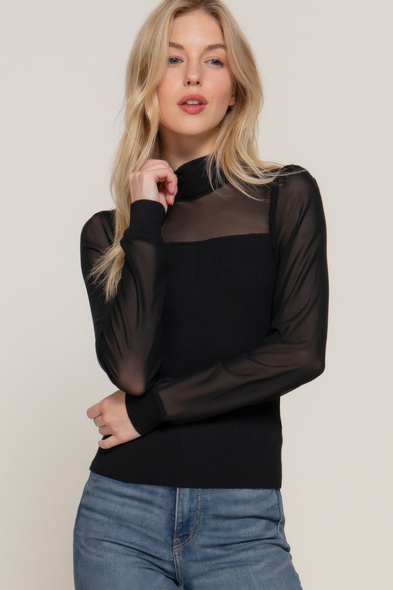 Black long-sleeve sweater top with sheer mesh sleeves and ribbed knit body