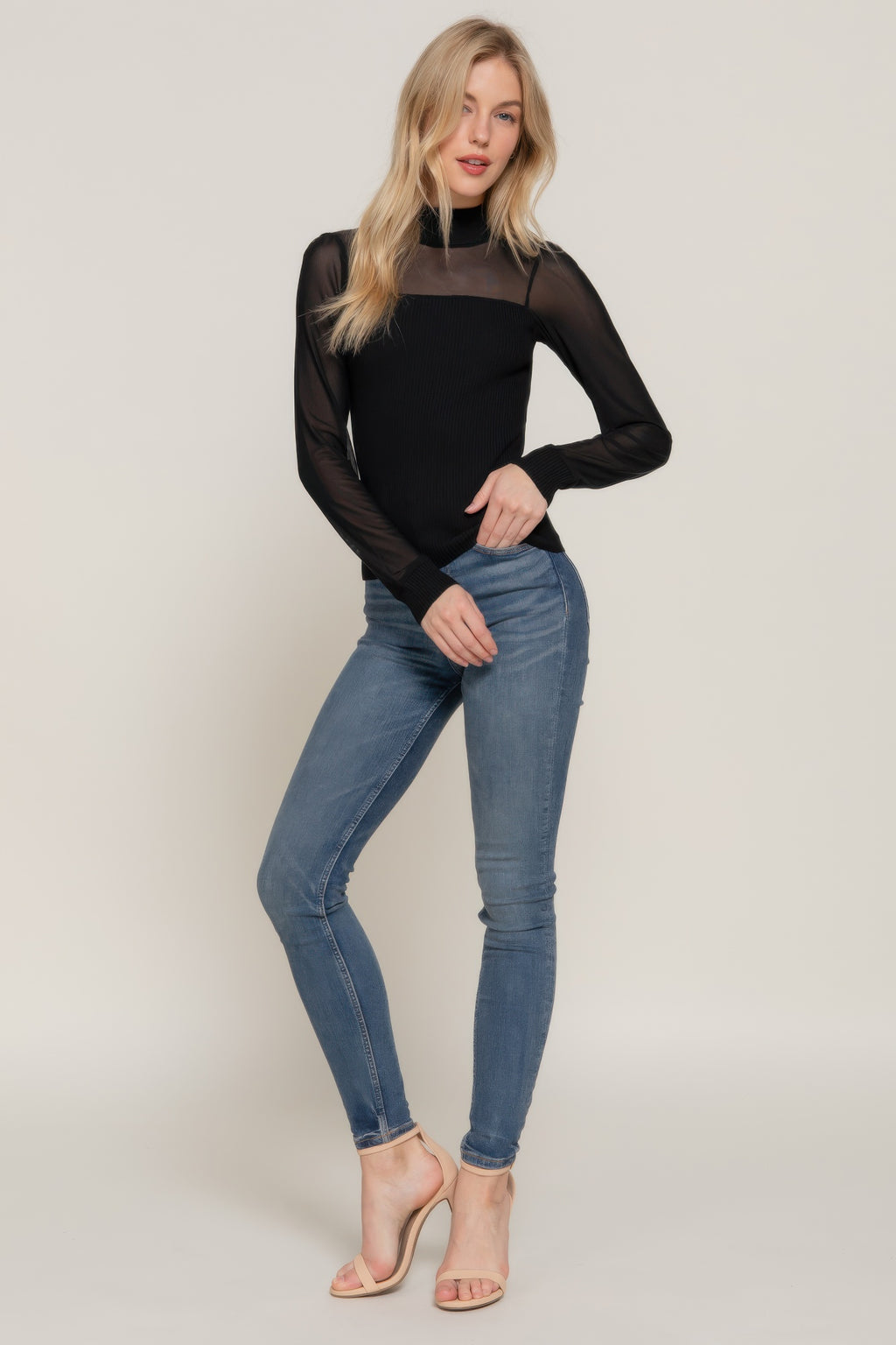 Black long-sleeve sweater top with high neckline, sheer mesh sleeves, ribbed knit