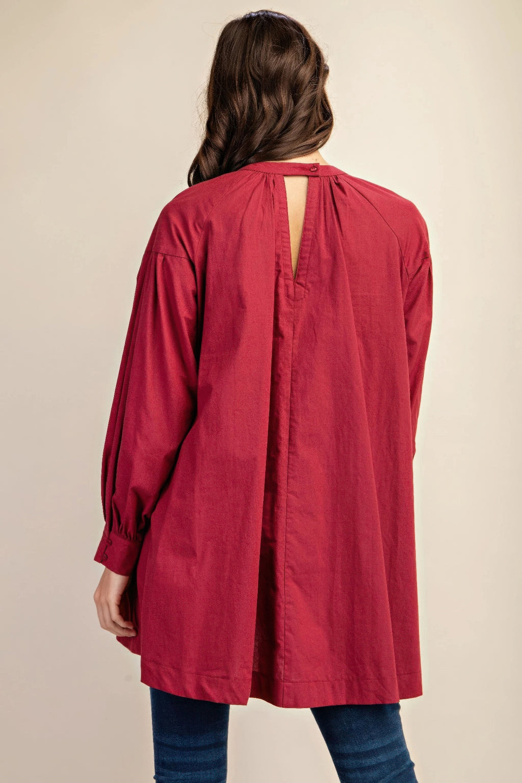 Plum mini dress back view with lace yoke, button placket and puff sleeves