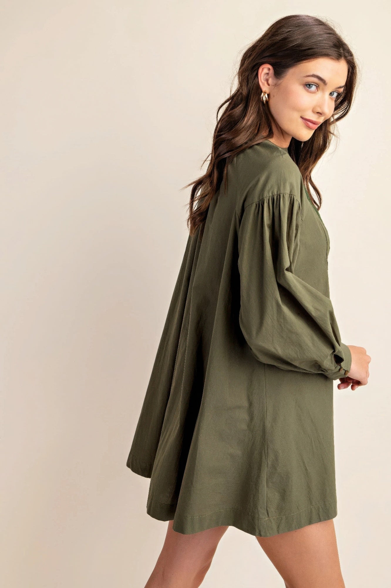 Olive long-sleeve mini dress with loose fit, lace yoke, and gathered skirt