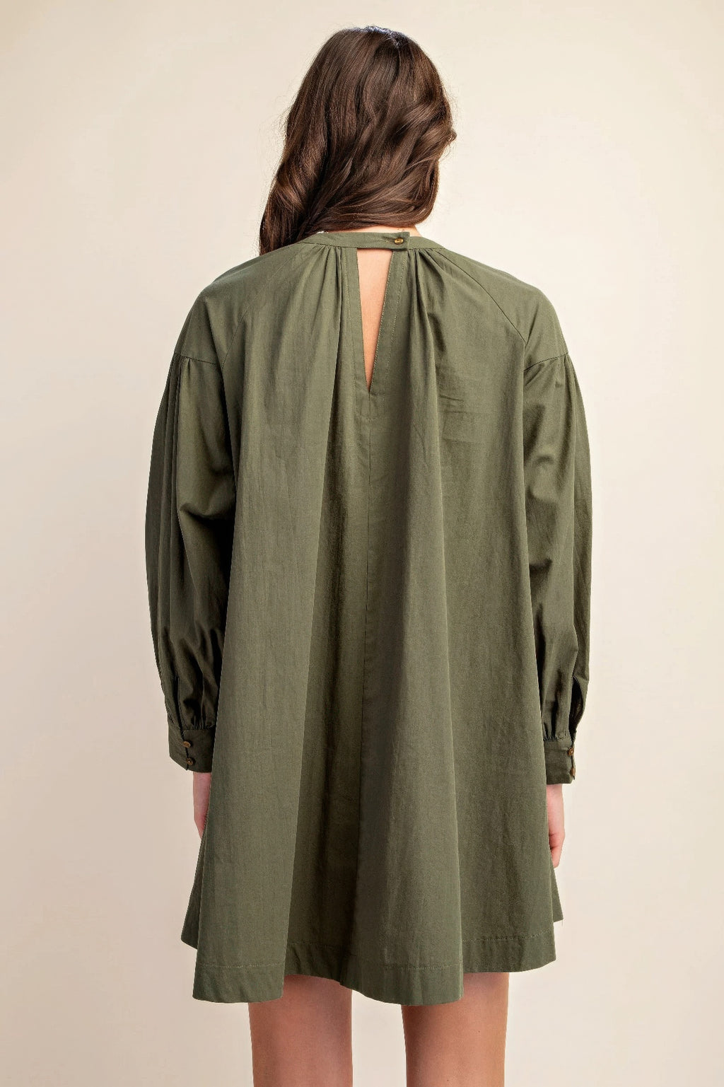 Back view of olive long-sleeve mini dress with keyhole neck opening
