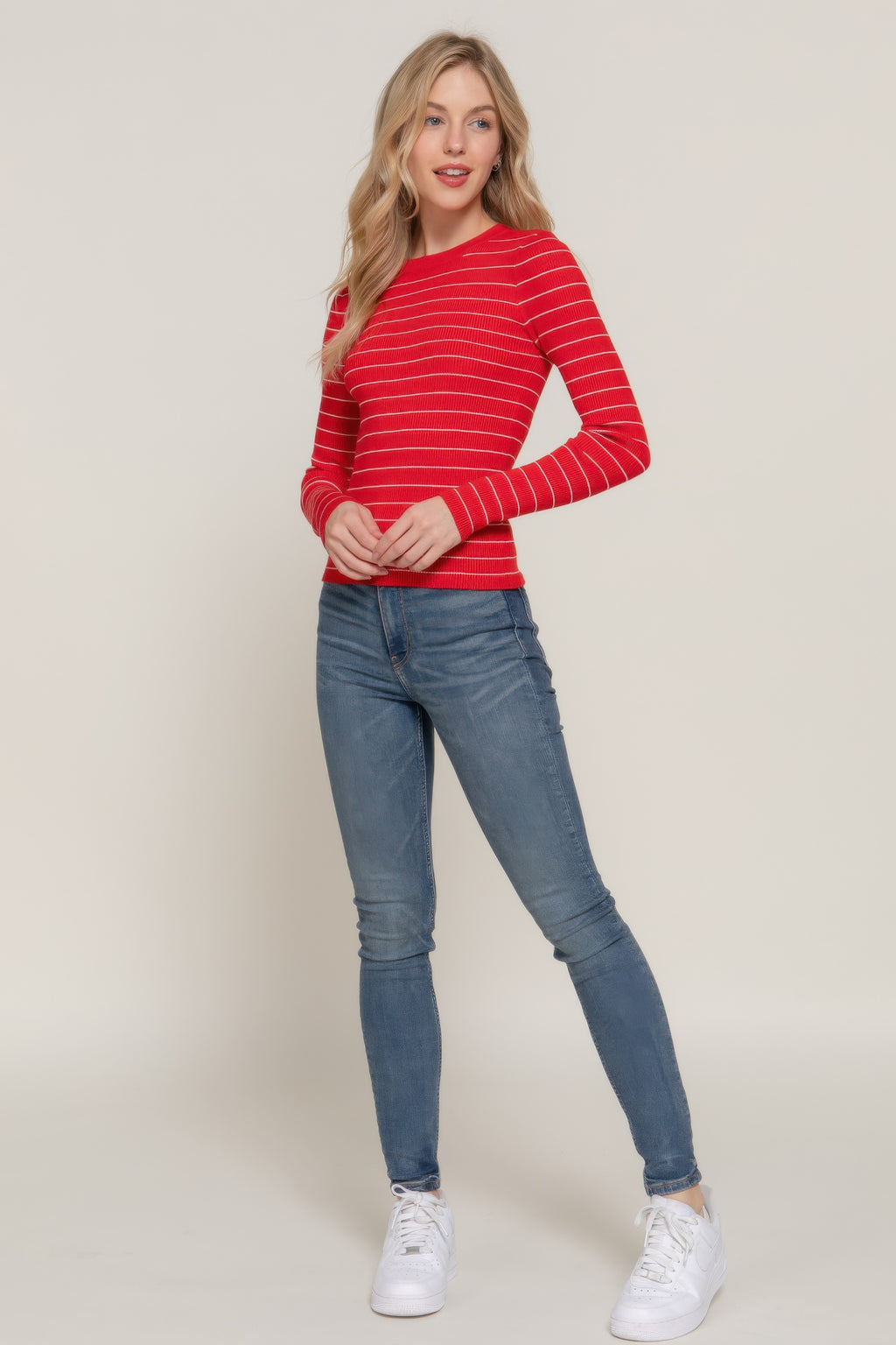 Red-and-white striped crew neck sweater with long sleeves and fitted ribbed hem