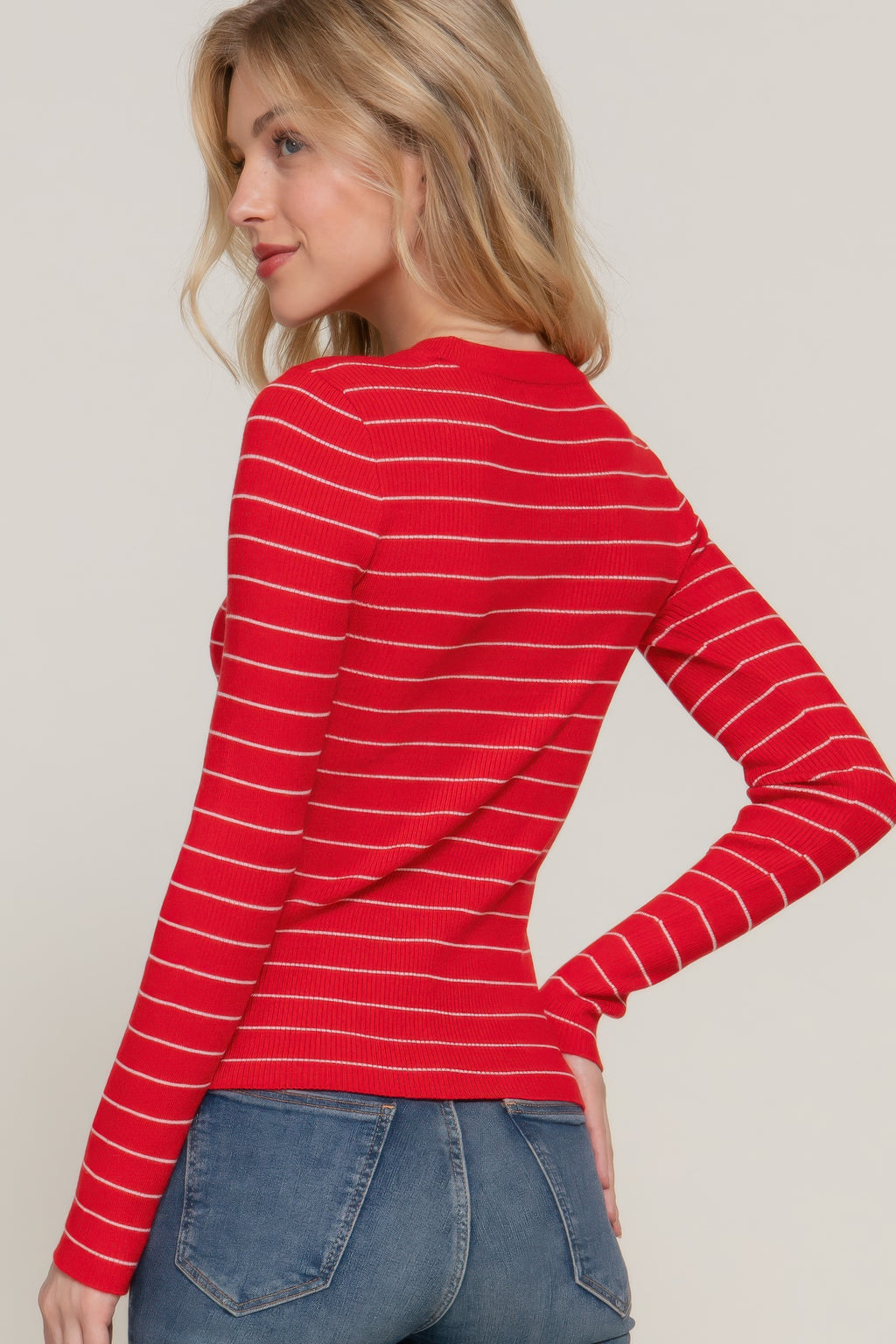 Red-and-white striped crew neck sweater, side view with long sleeves