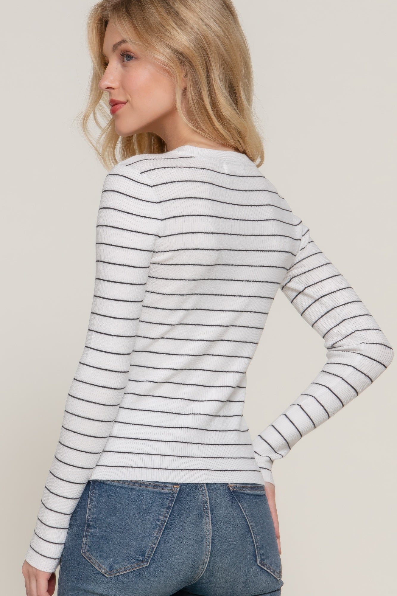 White-and-black striped crew neck sweater, back/side view with long sleeves