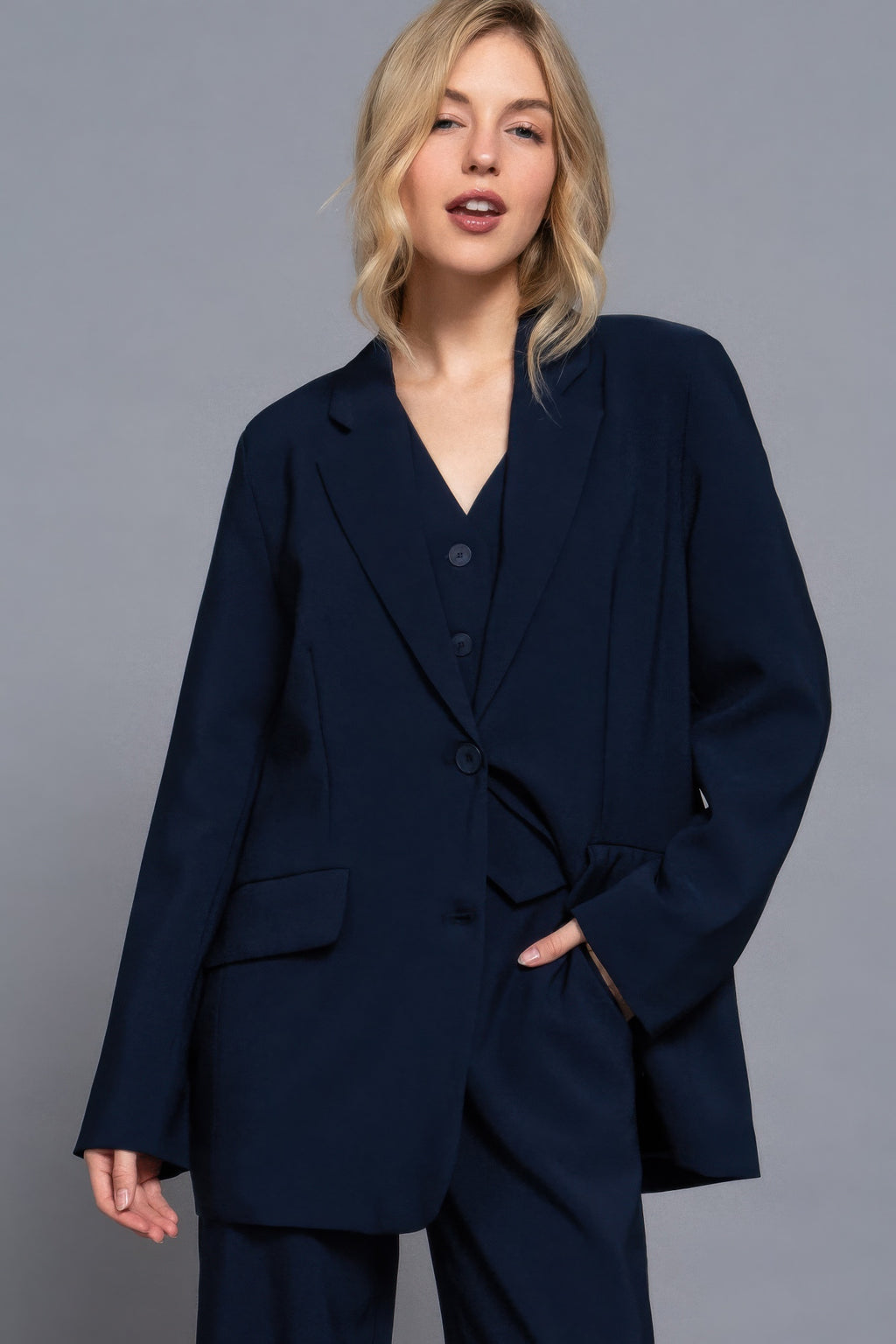 Long-sleeve blazer with front button closure, notch lapels, two front pockets (navy).