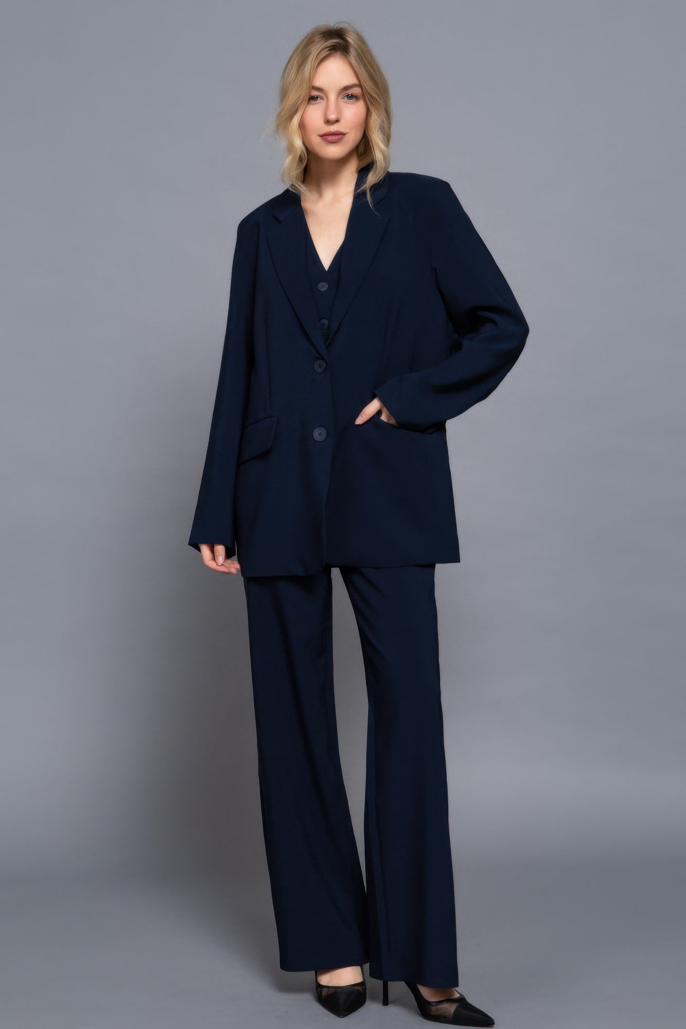 Navy long-sleeve blazer set with front buttons and two side pockets; straight-leg pants.