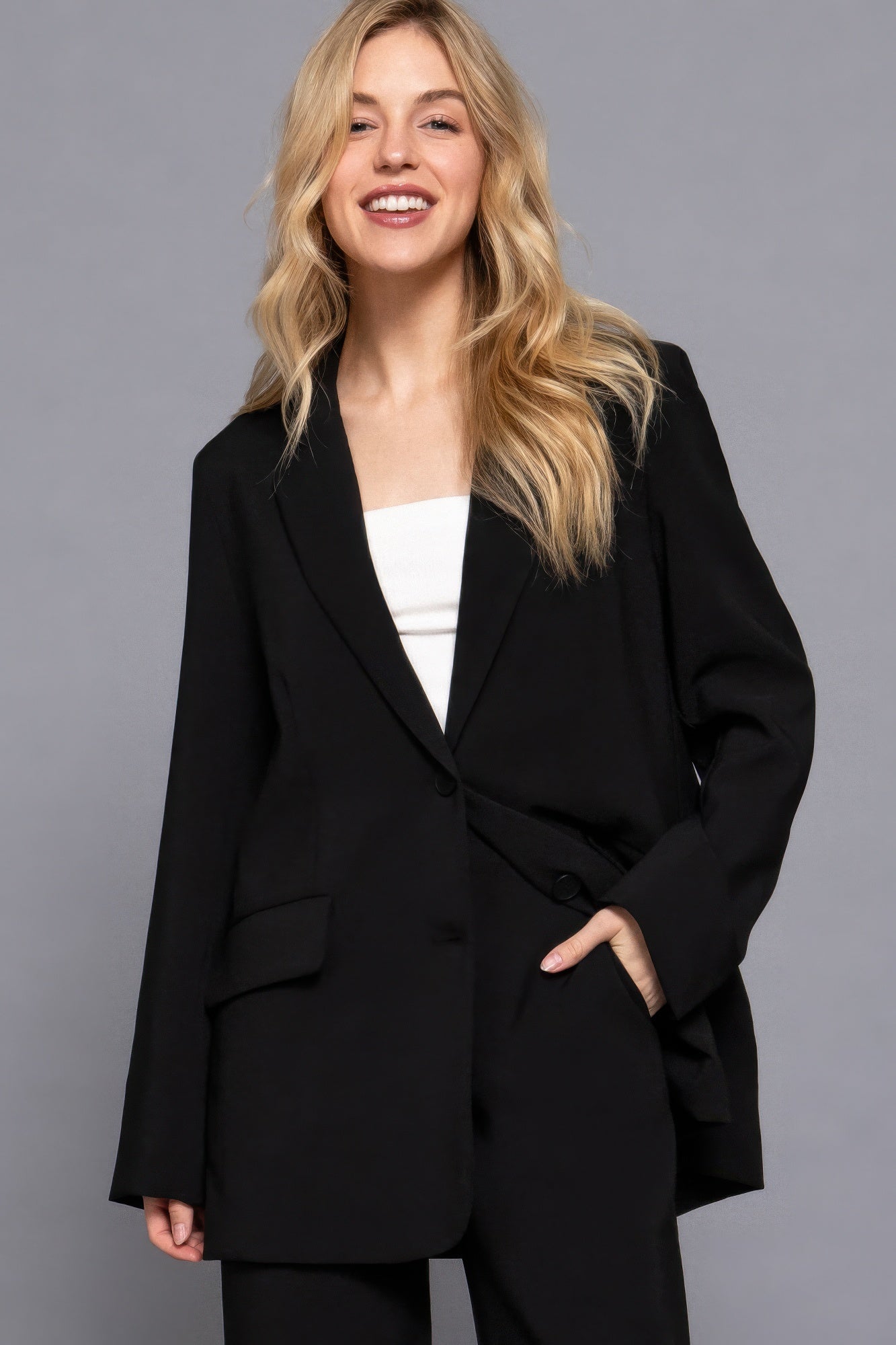 Black blazer with notched lapels and front button closure, roomy patch pockets.