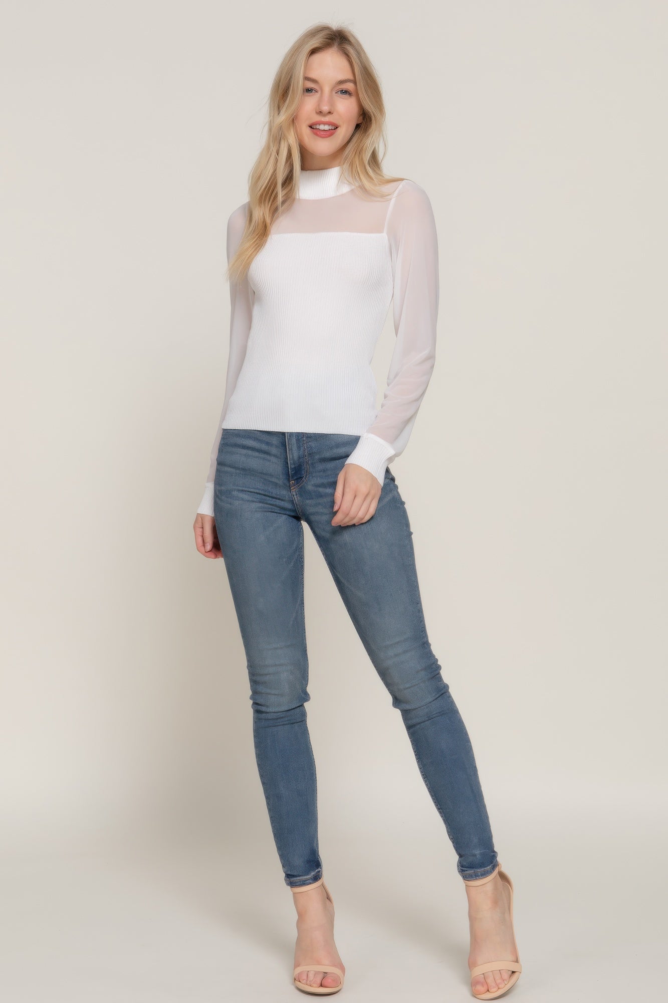 Off-white long-sleeve sweater top with sheer mesh overlay at the bust