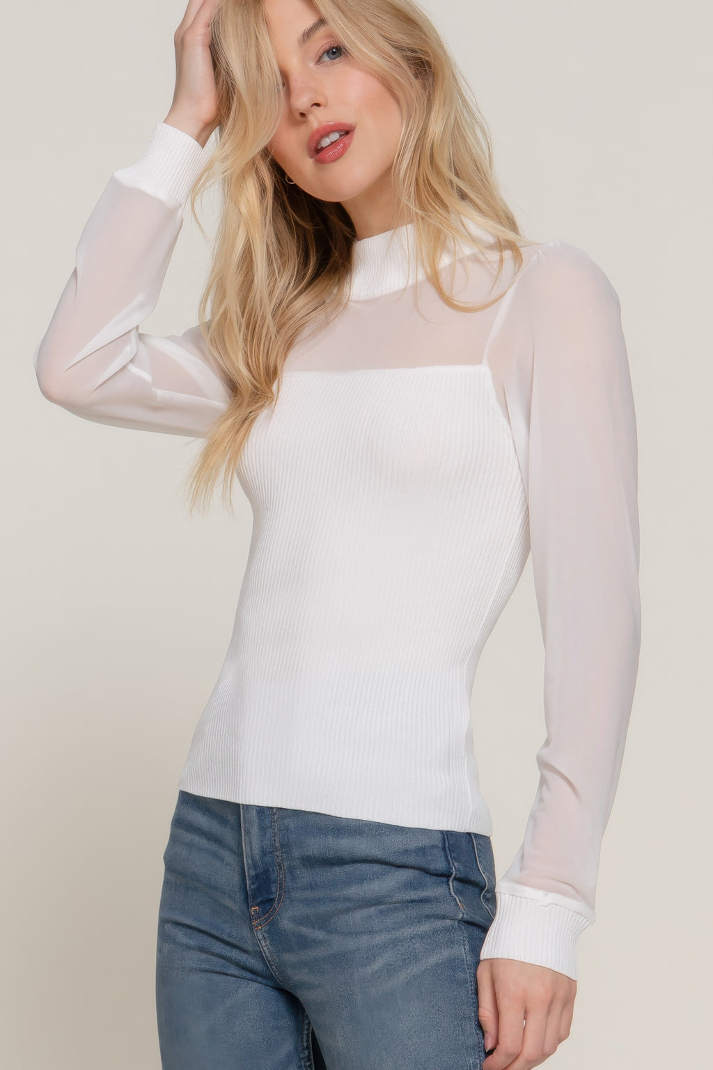 Off-white sweater top with sheer mesh chest panel and ribbed knit texture