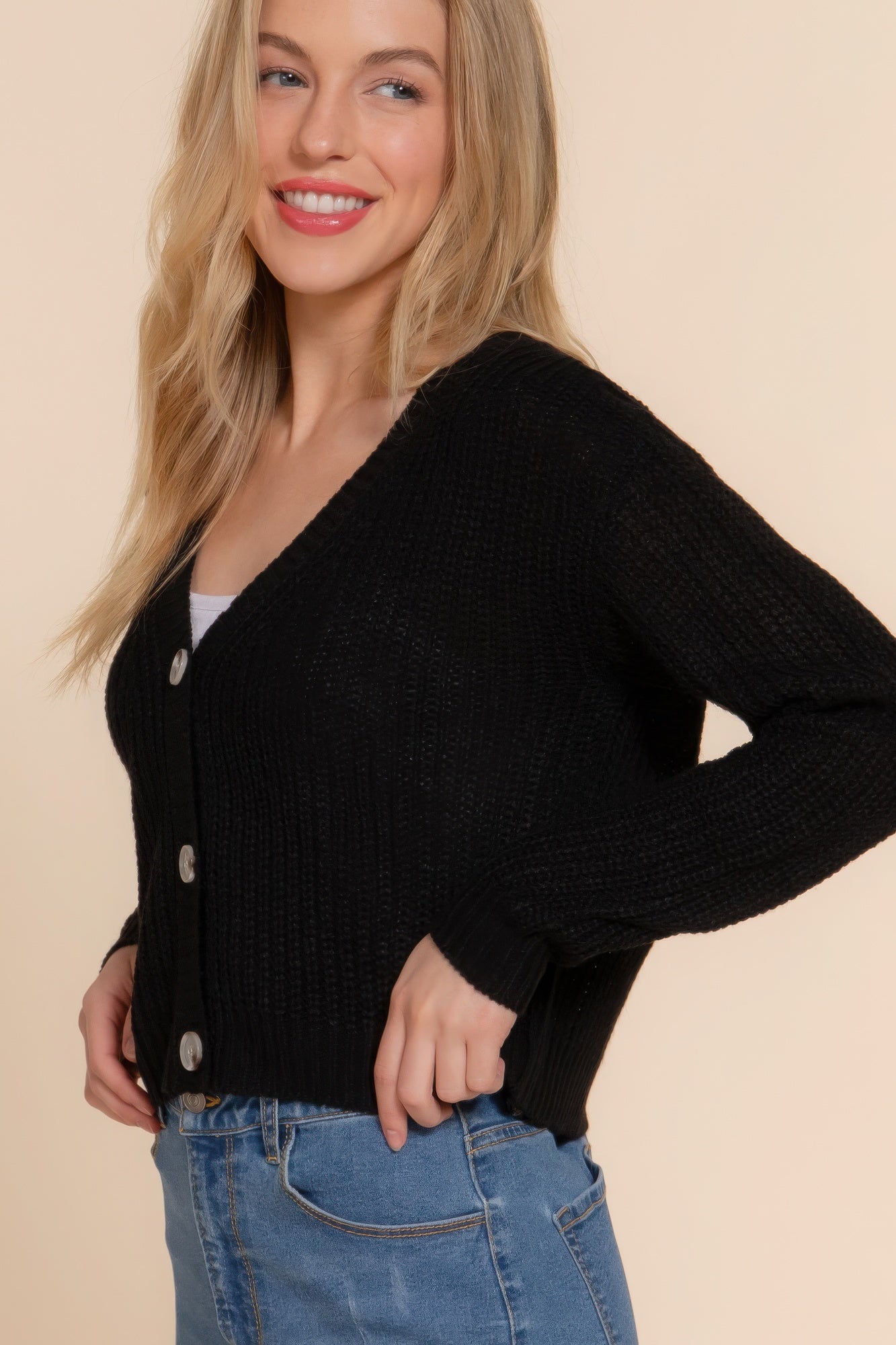 Black knit V-neck cardigan with silver button closures and long sleeves