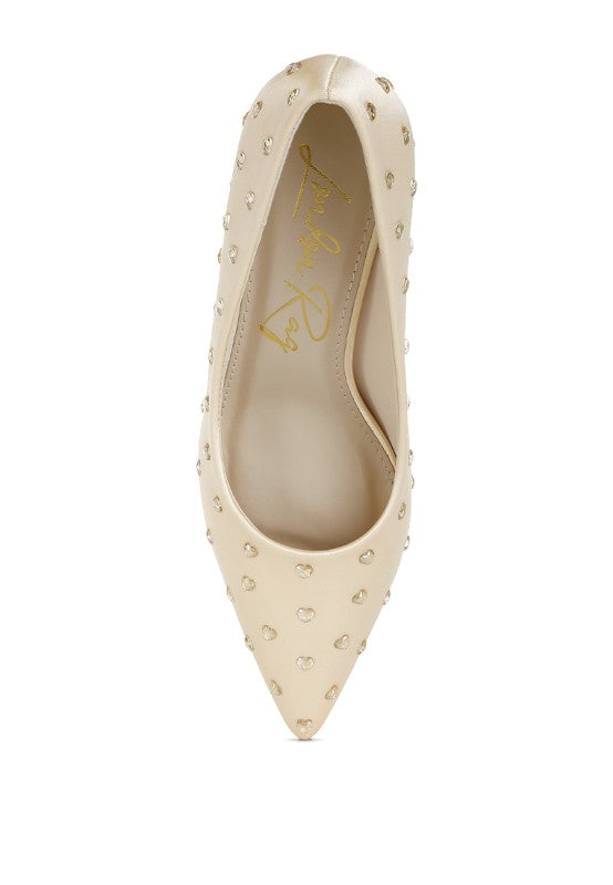 Beige front view of heart-shaped rhinestones on pointed-toe pumps