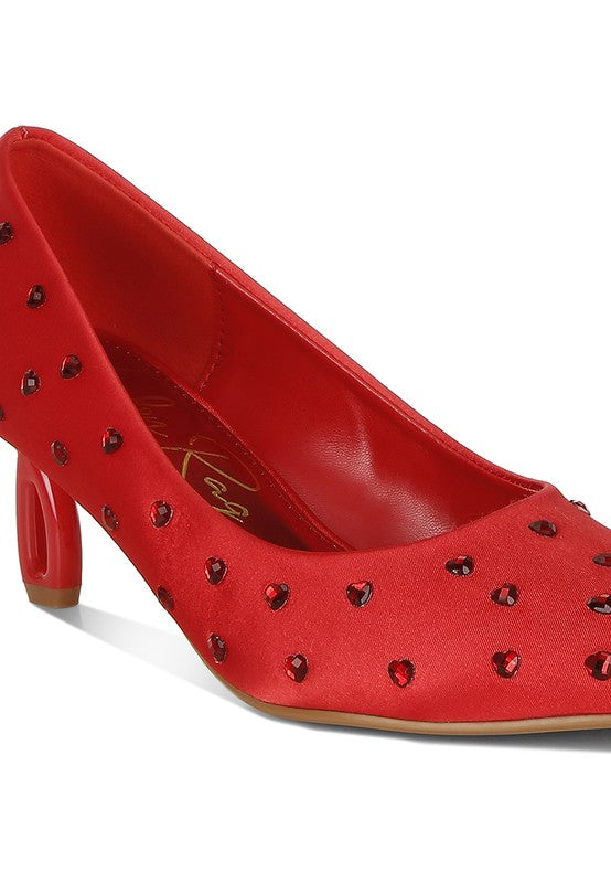 Close-up of red heart-rhinestone pumps with mid-height block heel